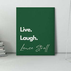 Puede incluir: Una impresión en lienzo verde con texto blanco que dice "Live. Laugh. Lance Stroll".
