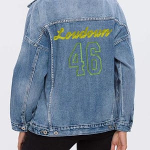 May include: A white ceramic mug with a black handle and the text "But First, Coffee" in a handwritten style. The mug is on a white surface. The mug is approximately 4 inches tall.