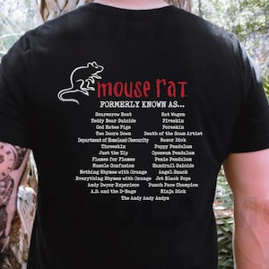 May include: Black t-shirt with a white rat illustration and the text "mouse rat" in red. The text "FORMERLY KNOWN AS..." is in red and lists a variety of humorous names in white.