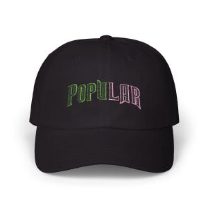 May include: Black baseball cap with the word "POPULAR" embroidered in green and pink letters.