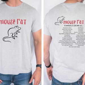 May include: A gray t-shirt with a black mouse rat illustration on the front and a list of names for the mouse rat on the back. The text on the back reads "mouse rat formerly known as..." followed by a list of names.