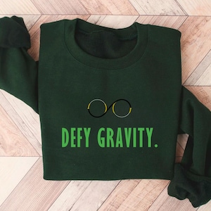 Defy Gravity-sweater Wizard of Oz-sweater heks roze en groene Elphaba-bril fanshirt Shiz For Good
