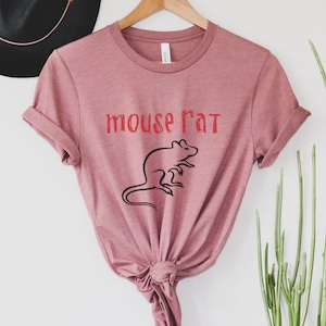 May include: A mauve t-shirt with the text "mouse rat" in red lettering and a black silhouette of a rat.