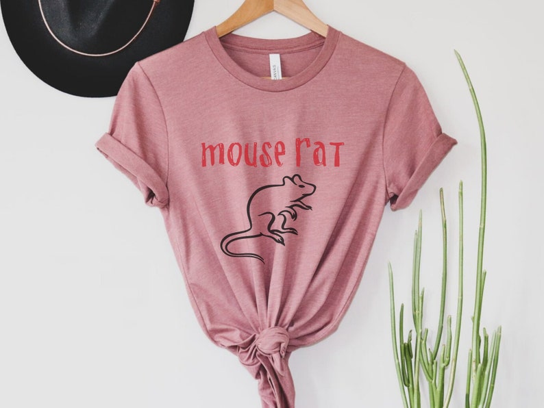 May include: A mauve t-shirt with the text "mouse rat" in red lettering and a black silhouette of a rat.
