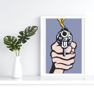 May include: A close-up of a hand holding a silver revolver with a yellow smoke plume coming from the barrel. The hand and gun are against a blue and white pixelated background.