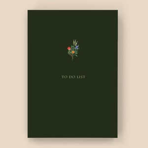 May include: A dark green to-do list notebook with a small floral illustration in the top centre. The flowers are orange, red, blue, and green.