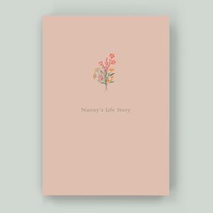 May include: A pink cover with a floral illustration and the text "Nanny's Life Story".