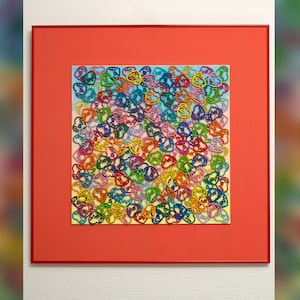May include: A framed artwork featuring a colorful collage of hearts with the word "love" written inside each heart.
