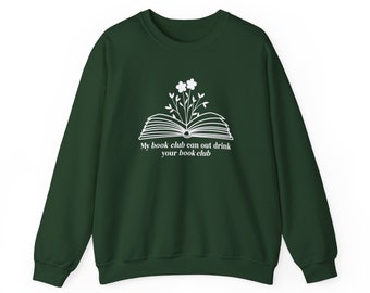 May include: A dark green sweatshirt with a white graphic of an open book with flowers growing out of it. The text "My book club can out drink your book club" is printed below the graphic.