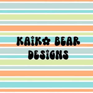 May include: A colorful striped background with the text "KAIK* BEAR DESIGNS" in black, retro-style font.