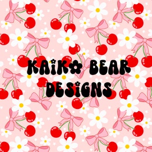 May include: A pink background with a repeating pattern of white daisies, pink bows, and red cherries. The text "KAIK* BEAR DESIGNS" is in the center of the image.