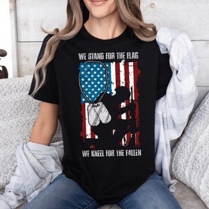 a woman wearing a t - shirt with the american flag on it