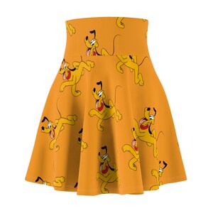 May include: A yellow skirt with a pattern of cartoon dogs running. The skirt is a skater style with a high waist.