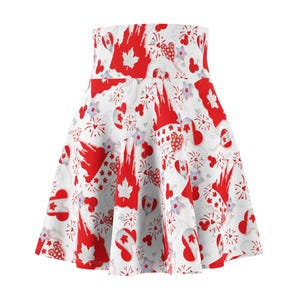 May include: A white skater skirt featuring a repeating pattern of red maple leaves, fireworks, hearts, and castle silhouettes. The skirt has a high waist and a flared design, suitable for casual or festive wear.