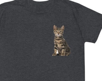May include: A dark heather grey t-shirt with a small image of a tabby cat sitting on the front.
