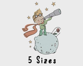 May include: An embroidered design featuring a cartoon illustration of a young boy with a telescope, standing on a planet. The boy wears a green outfit, goggles, and a scarf. The design includes stars and the text "5 Sizes".