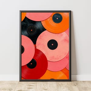 May include: Framed art print featuring a vibrant arrangement of vinyl records. The records are in shades of red, pink, orange, and black, creating a colorful and retro aesthetic. The black frame adds a modern touch to the vintage theme.