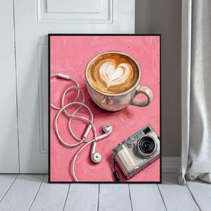 May include: An oil painting on a pink background featuring a ceramic mug filled with coffee displaying heart-shaped latte art, a pair of white wired earbuds with a tangled cord, and a silver compact digital camera positioned in the lower corner.