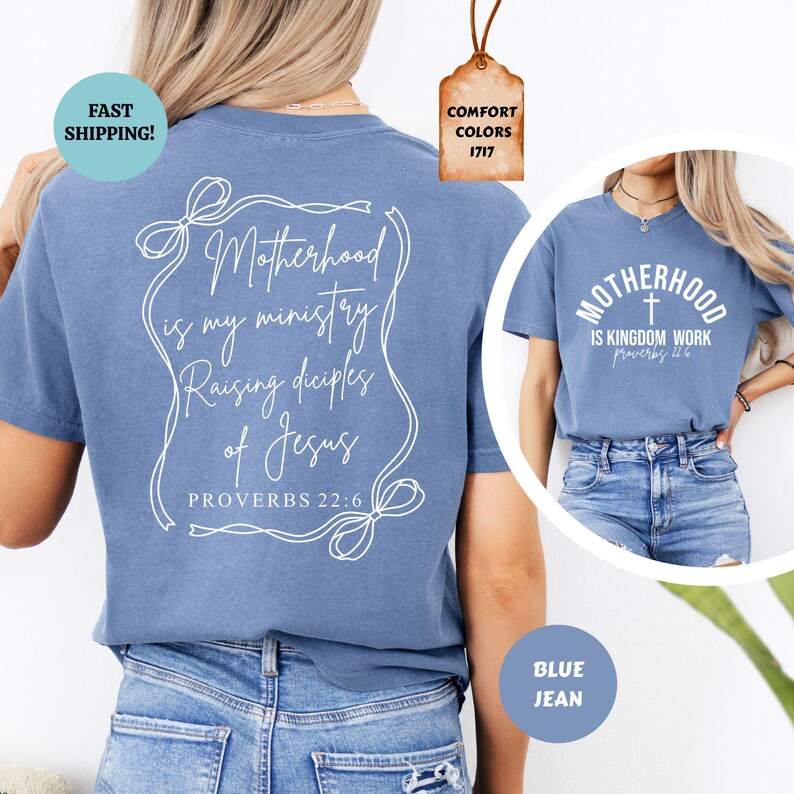 May include: A blue t-shirt with white text that reads "Motherhood is my ministry Raising disciples of Jesus Proverbs 22:6". The shirt is shown on a model wearing blue jeans.