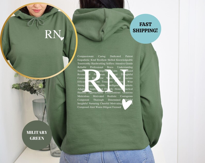 May include: A military green hoodie with a white 'RN' and a heart on the front. The back of the hoodie has a list of positive words describing a registered nurse.