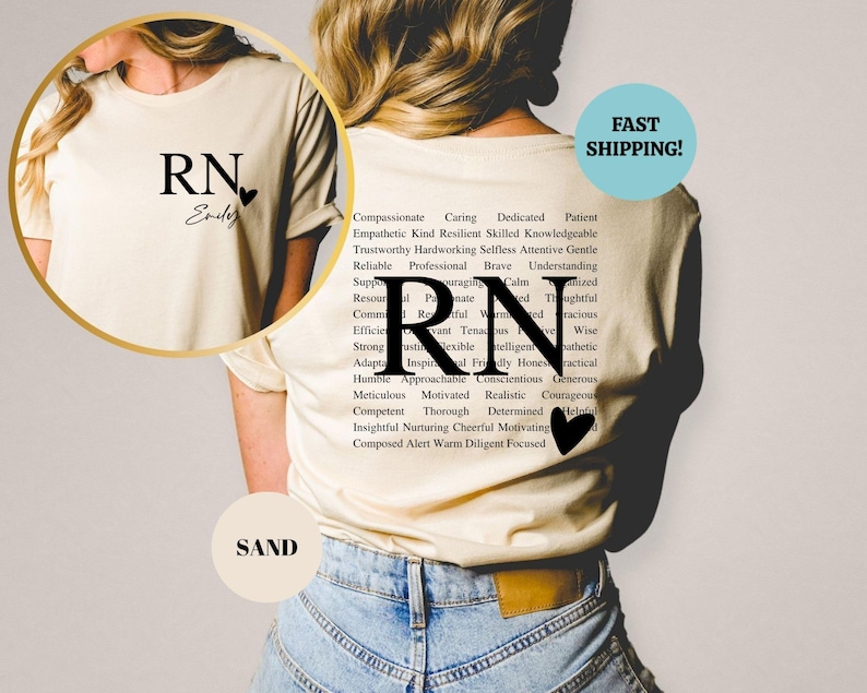 May include: A white t-shirt with the letters "RN" and the word "Endey" printed on the front. The back of the shirt has the letters "RN" printed in large font with a list of positive adjectives surrounding the letters. The adjectives include words like compassionate, caring, dedicated, patient, empathetic, kind, resilient, skilled, knowledgeable, trustworthy, hardworking, selfless, attentive, gentle, reliable, professional, brave, understanding, resourceful, passionate, calm, thoughtful, committed, relevant, tenacious, intelligent, wise, efficient, strong, flexible, honest, authentic, adaptable, inspirational, friendly, honest, practical, humble, approachable, conscientious, generous, meticulous, motivated, realistic, courageous, competent, thorough, determined, helpful, insightful, nurturing, cheerful, motivating, composed, alert, warm, diligent, and focused.