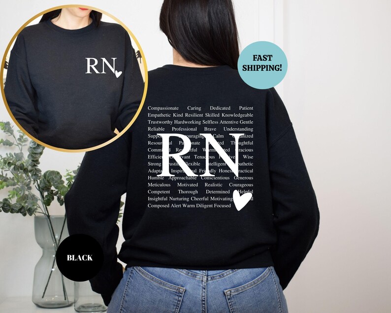 May include: Black sweatshirt with a white 'RN' with a heart on the front and a list of positive adjectives describing a registered nurse on the back.