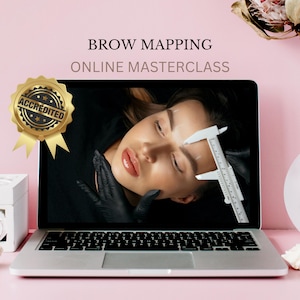May include: A laptop computer screen shows a woman receiving a brow mapping service. The text "BROW MAPPING ONLINE MASTERCLASS" is displayed above the image. A gold seal with the word "ACCREDITED" is in the upper left corner of the image.