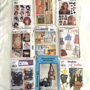 May include: A collection of vintage sewing patterns for bags, hats, and aprons. The patterns are from Simplicity, Butterick, and McCall's. The patterns feature a variety of styles, including tote bags, handbags, and aprons. The patterns are in various colors, including red, blue, green, and yellow.