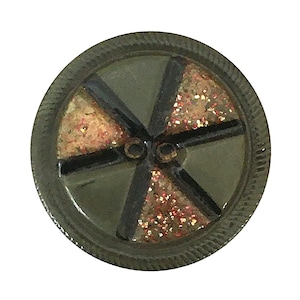 May include: A round, olive green button with a textured edge. The button features a segmented design with black lines and sections filled with gold and red glitter. Two small holes are visible in the center.