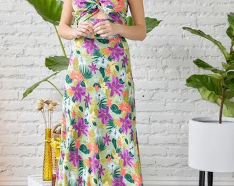 May include: A strapless maxi dress with a knotted bodice and a tropical floral print in shades of green, purple, orange, and yellow.