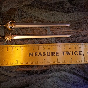 Measurement of sword pins (~15.5 cm) next to a ruler.
