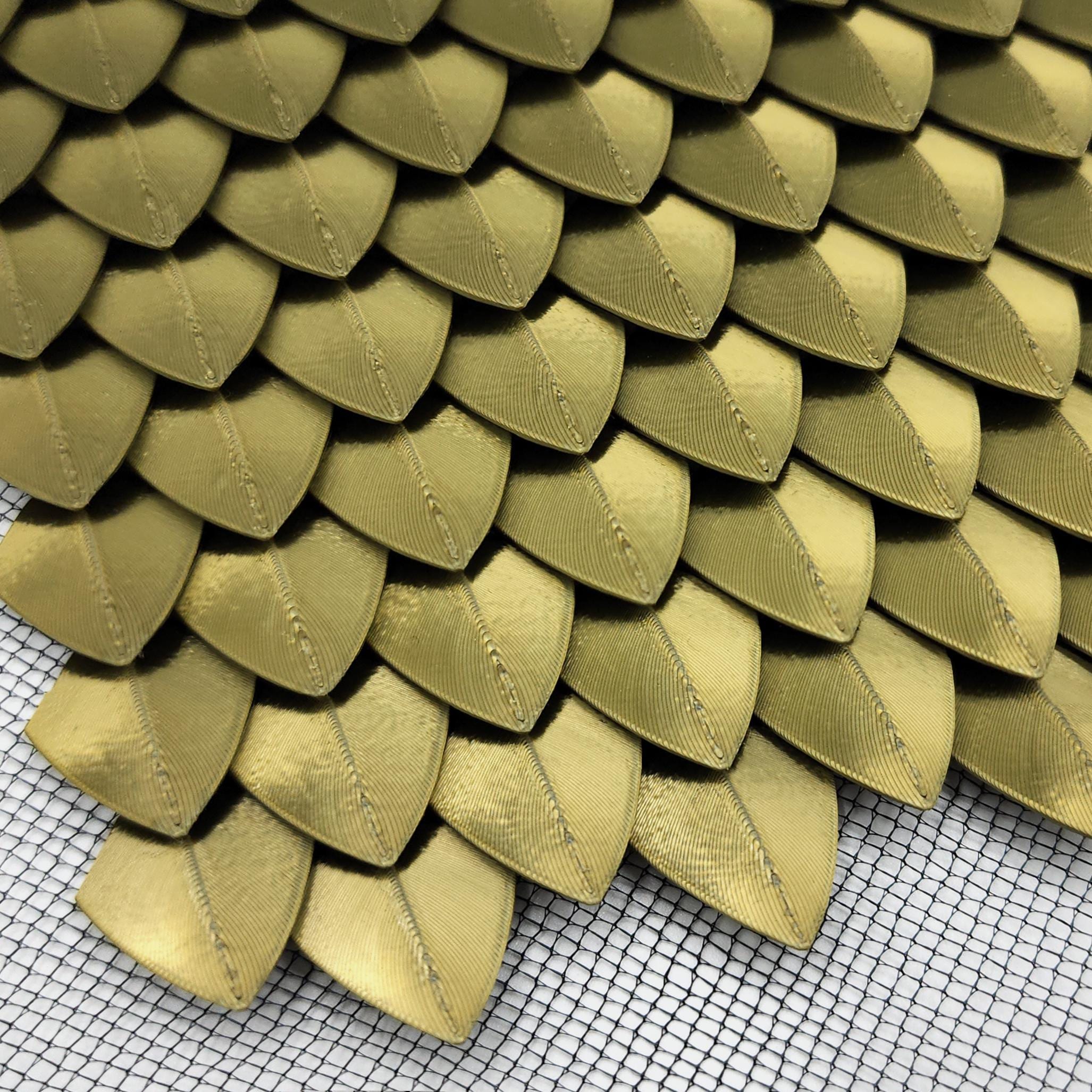 3D Printed Metallic Dragon Scales on Sheets of Mesh Fabric