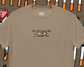 May include: A tan t-shirt with the text "DO NOT GIVE ME A CIGARETTE" and a cartoon cigarette with eyes on it. The shirt has a small logo that says "Goblin Bard" in the top center.