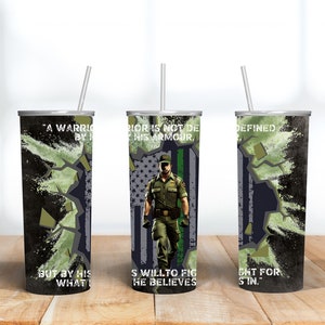 May include: A stainless steel tumbler with a straw, featuring a design of a person in a uniform in front of an American flag. The tumbler has text that reads "A warrior is not defined by his armour, but by his will to fight for what he believes in."