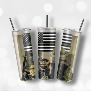 May include: Three stainless steel tumblers with a green, black, and white American flag design. The tumblers feature a US Border Patrol theme with images of a badge, a gun, a vest, boots, and a backpack. The text "U.S. Border Patrol" is visible on the tumblers.