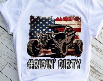 May include: White t-shirt with a distressed American flag design and a brown off-road vehicle. The text "#RIDIN' DIRTY" is printed below the vehicle.