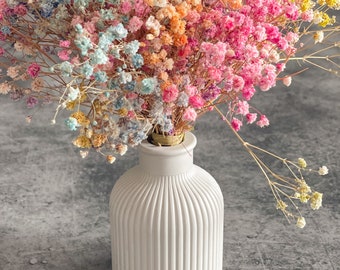 An elegant vase, light gray, made of cement