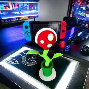 Switch Plant Stand mini - Docka med laddningsfunktion (TV-läge möjligt) Switch Stand & Display – 3D-utskriven spelpresent