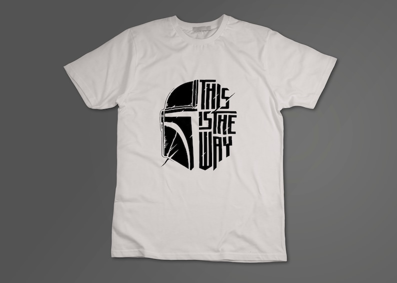 May include: White t-shirt with a black graphic of a Mandalorian helmet and the text "This is the way".