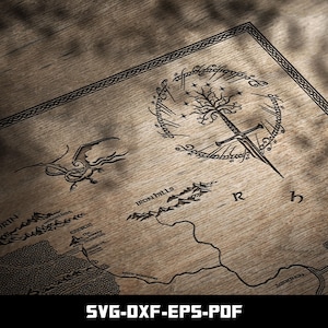 May include: Wooden map with intricate black line art depicting a fantasy world. Features a sword, tree, and ring design, along with geographical elements and text. The bottom of the image displays "SVG-DXF-EPS-PDF".
