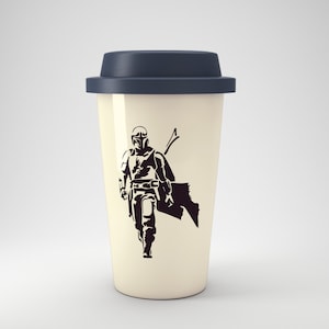 May include: A white travel mug with a black silhouette of a Mandalorian character. The mug has a dark blue lid.