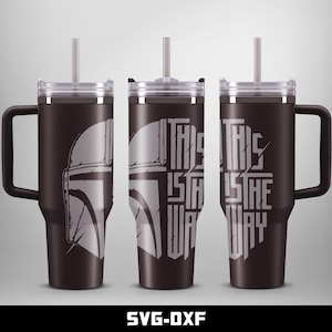May include: A black stainless steel tumbler with a lid and a straw. The tumbler has a graphic of a Mandalorian helmet and the text "This is the way".