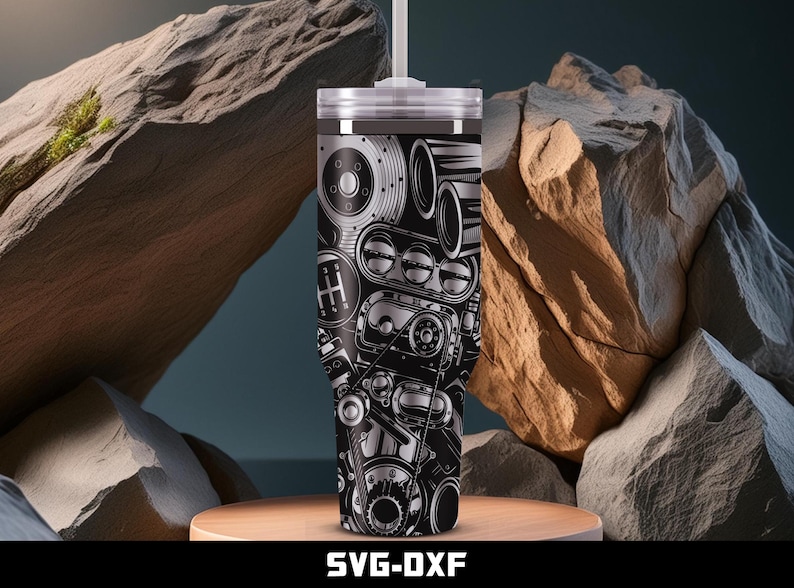 May include: A stainless steel tumbler with a black and silver engine design. The design includes gears, a transmission, and other engine components. The tumbler has a white lid and a straw. The text "SVG-DXF" is at the bottom.