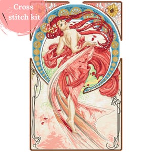May include: Cross stitch kit featuring a woman in a flowing red dress with a floral background. The woman has long red hair and is depicted in a stylised art nouveau style.