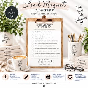 May include: A Lead Magnet Checklist document on a wooden clipboard, surrounded by a potted plant, a coffee cup, a pen holder with pens, and glasses. The text includes 'Lead Magnet Checklist', 'Create | Attract | Grow', and 'Small Freebie Big Opportunities'.