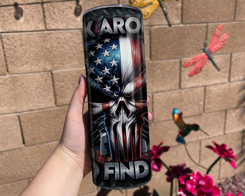 May include: A black and red stainless steel tumbler with a skull graphic and an American flag design. The text "KARO FIND" is printed on the tumbler.