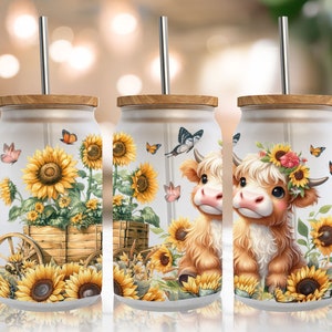 May include: Three white tumblers with a wood lid and a metal straw. Each tumbler features a different design of a brown and white cow with sunflowers and butterflies.