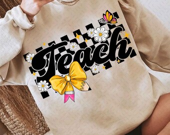 May include: A beige sweatshirt with a black and white checkered pattern, a yellow bow, a pink pencil, and the word "Teach" in black. The design also includes white flowers and a butterfly.
