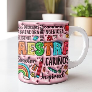 May include: Pink ceramic mug with a colorful design that says "MAESTRA" and includes words like "dedicadas", "cari&ntilde;osa", "motivada", "ingeniosa", "linda", "cari&ntilde;os", and "inspirad".