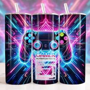 May include: A gamer-themed stainless steel tumbler with a neon blue and pink design. The tumbler features a video game controller with a label that reads "Gamer Fuel Nutrition Facts".